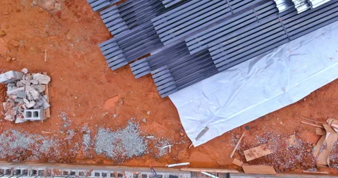 Construction site with materials and debris on the ground in a developing area Stock Footage 295285736