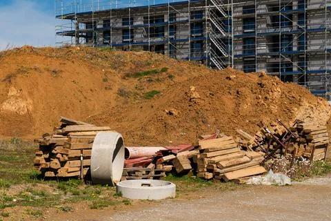 Construction site with materials and dirt pile near building Stock Photos