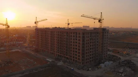 Construction site in the middle of the city and private houses at sunset in 4K. Video stock 123843373