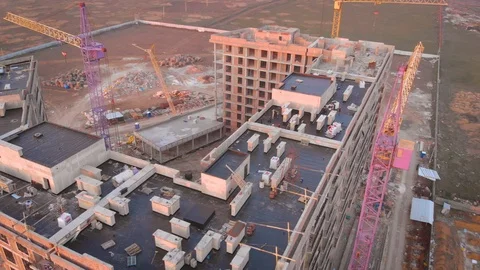 Construction site in the middle of the city and private houses at sunset in 4K. Stock Footage 123844745