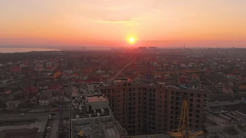 Construction site in the middle of the city and private houses at sunset in 4K. Video stock 123846541