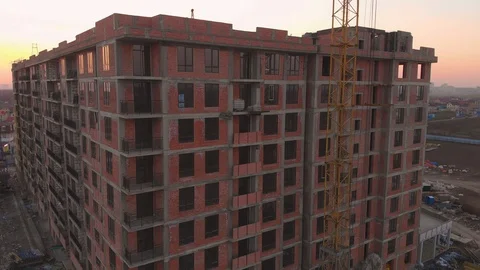 Construction site in the middle of the city and private houses at sunset in 4K. Video stock 123846885