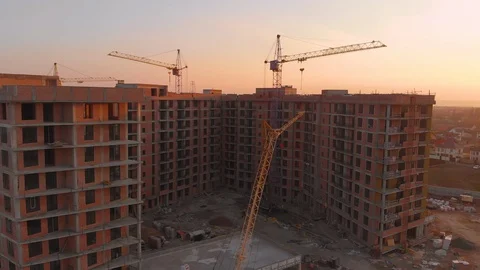 Construction site in the middle of the city and private houses at sunset in 4K. Video stock 123847342