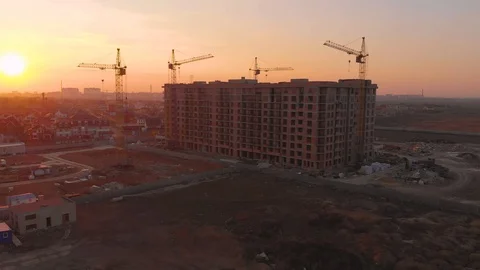 Construction site in the middle of the city and private houses at sunset in 4K. Video stock 123848261