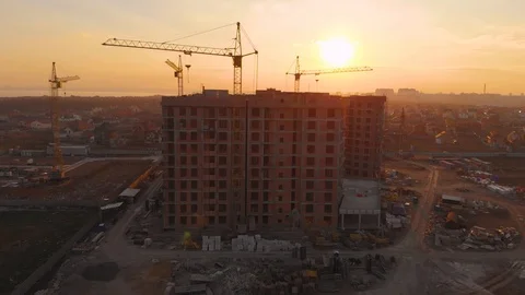 Construction site in the middle of the city and private houses at sunset in 4K. Video stock 123848445