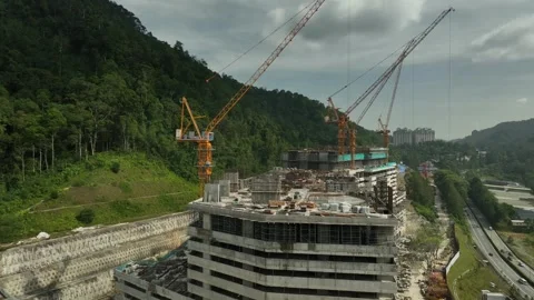 Construction Site on Mountain with Cranes and Building Progress Surrounded by Video stock 316450374