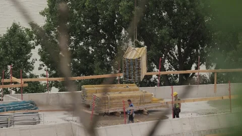 Construction site moving material with crane Stock Footage 306274872