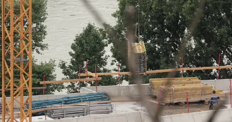 Construction site moving material with crane Stock Footage 311172781