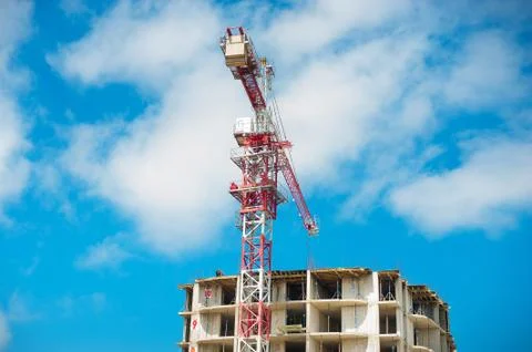 Construction site of multistore building with tower cranes and blue sky Stock Photos