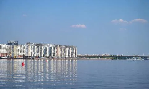 Construction site of new buildings, view from the river to the new neighborho Stock Photos