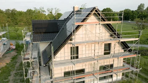 Construction site of a new detached house with solar panels on the roof Stock Footage 242765317
