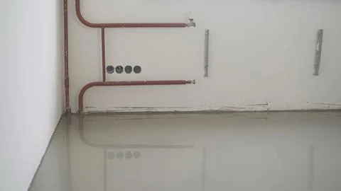 Construction site with new self leveling floor, heating pipes and reflection Stock Photos