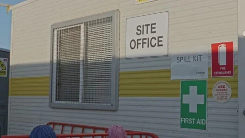 Construction site office room with various safety signage Stock Footage 234314322