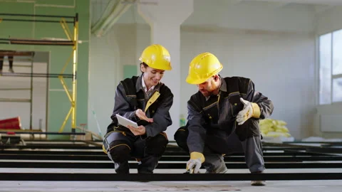 At construction site one engineer woman and good looking man constructor worker Stock Footage 170151384