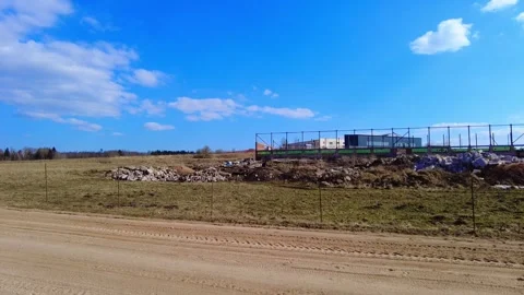 Construction site in open field with blue sky and clouds in background near rura Stock-Footage 332564692