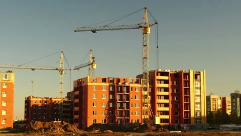 Construction site at orange sunset. Silhouette of high tower cranes works on Stock-Footage 160464146