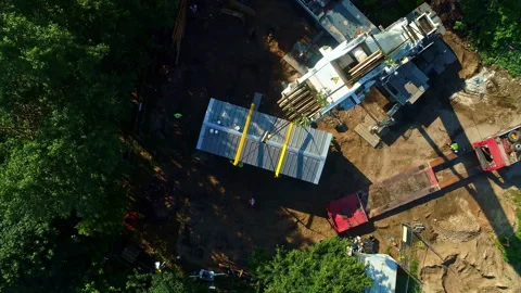 Construction Site with Overhead View of Crane Lowering Assebled Modul House Stock Footage 291603195