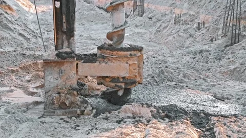 Construction Site Pale Driver Equipment Drill Covered in Fresh Concrete Cement Stock Footage 277875933