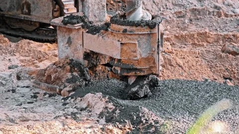 Construction Site Pale Driver Equipment Drill Covered in Fresh Concrete Cement Stock Footage 277875942