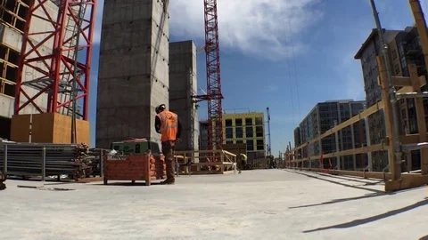 Construction Site Pan left from Materials and worker Stock Footage 81457281