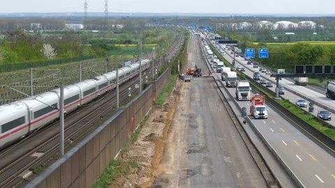 Construction site, passing ICE train and dense traffic on German highway Stockbeeldmateriaal 239566539