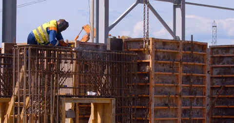 At the construction site of a plant under construction, a welder holds fittings  Stock Footage 161986438
