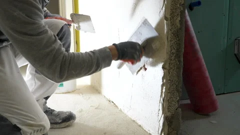 Construction site - Plastering a wall - unrecognisable person Stockbeeldmateriaal 241940523