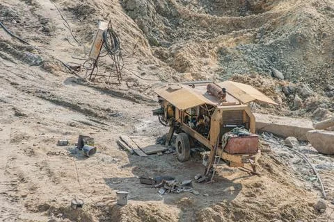 Construction Site with Portable Machine on Sandy Terrain Stockfoto's