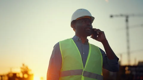 Construction site, portrait of african american female talking by mobile phone Stock Footage 318342853