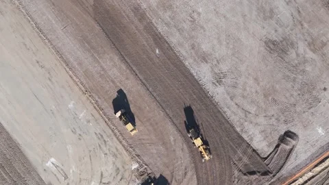 Construction site preparation at sunrise featuring heavy machinery reshaping the Stock Footage 281333499