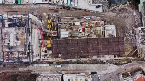 Construction site in progress near water with cranes and buildings visible Stock Footage 332211555