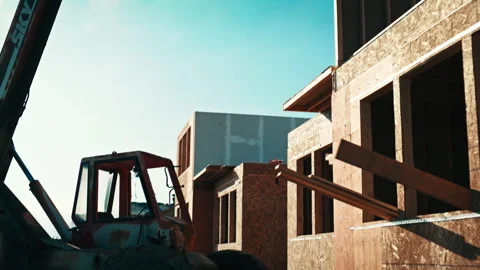 Construction site progress with tractor moving building materials Stock Footage 310160304