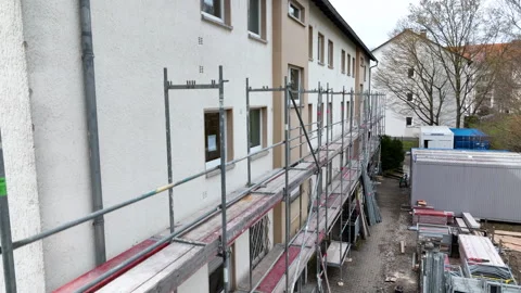 Construction site - putting up a scaffolding Видео 248452537