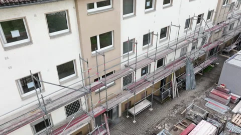 Construction site - putting up a scaffolding Видео 248452630