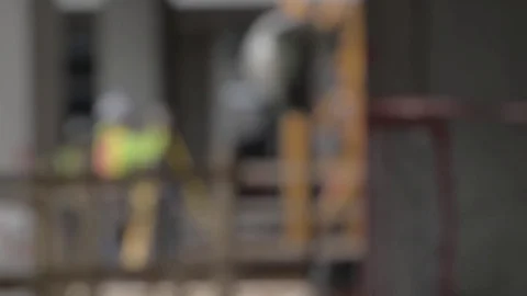 Construction Site Rack Focus to Worker using Transit Level Stock Footage 81457285