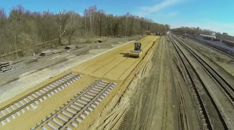 Construction site of railway with road roller flattens sand Stock Footage 42348209