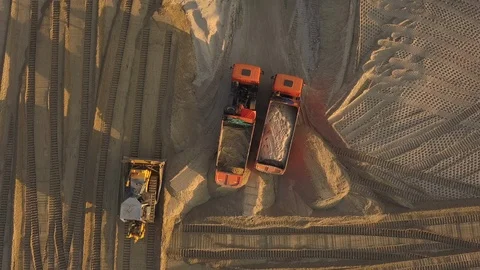 Construction site on the road construction site. Dump trucks with sand Video stock 111703446