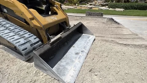 COnstruction site road replacement with Caterpiller (CAT) 262D skid steer pan Stock Footage 217402637
