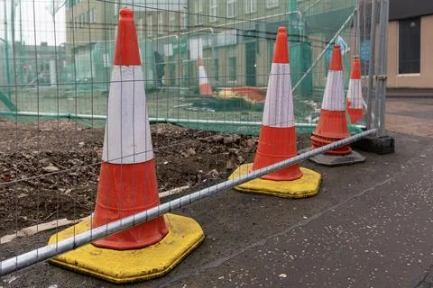 Construction Site with Row of Public Safety Traffic Cones and Temporary Fence Stock Photos