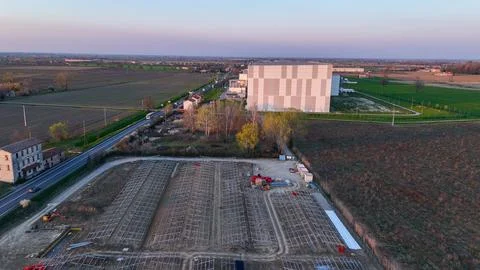 Construction site in a rural field with rows of metal frames being installe.. Stock Photos