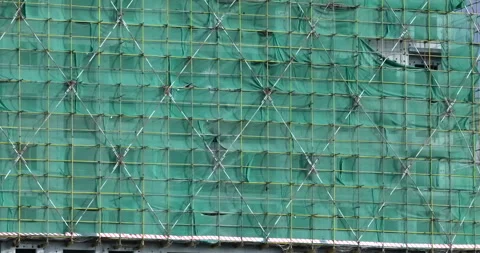 Construction site safety netting sways in the wind Stock Footage 294476218