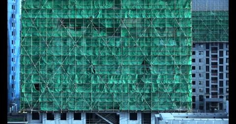 Construction site safety netting sways in the wind Stock Footage 294476609
