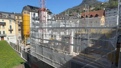 Construction site with scaffolding and crane in urban Switzerland Stockbeeldmateriaal 332558628