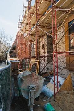 Construction site with scaffolding and tools on a sunny day in an urban area Photos