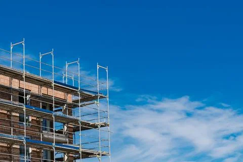 Construction site with scaffolding under a clear blue sky Stock Photos