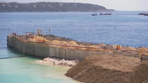 Construction site on the sea with workers and materials in 4K Vídeos de archivo 316296885