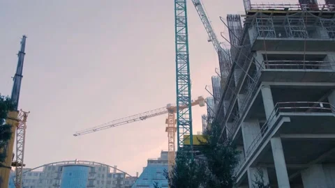 Construction site with several cranes working on a building skyscraper houses Stock Footage 226136487