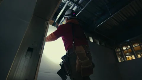 Construction Site: Sheetrock work in the dark 스톡 동영상 224969540