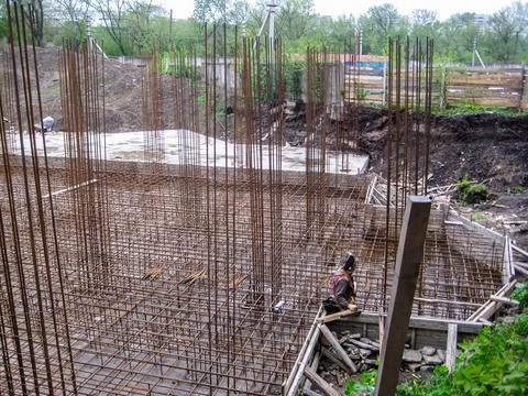 The construction site showcases rebar frameworks and the initial concrete gro Stock Photos