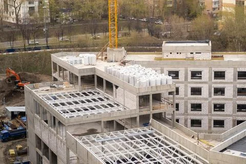 Construction Site Showcasing Progress on a Multi-Story Building With Cranes and Stock Photos